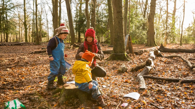 Family on a nature trail during Autumn at Leigh Woods, Bristol